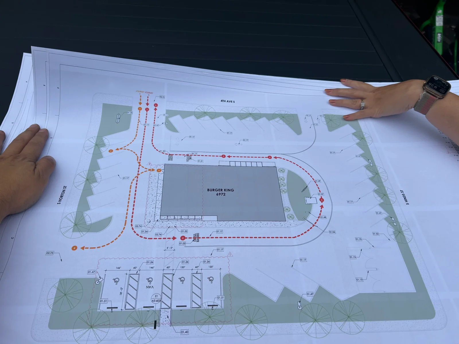 Architectural site plan with landscape design, tree placement, and utility routing for commercial property