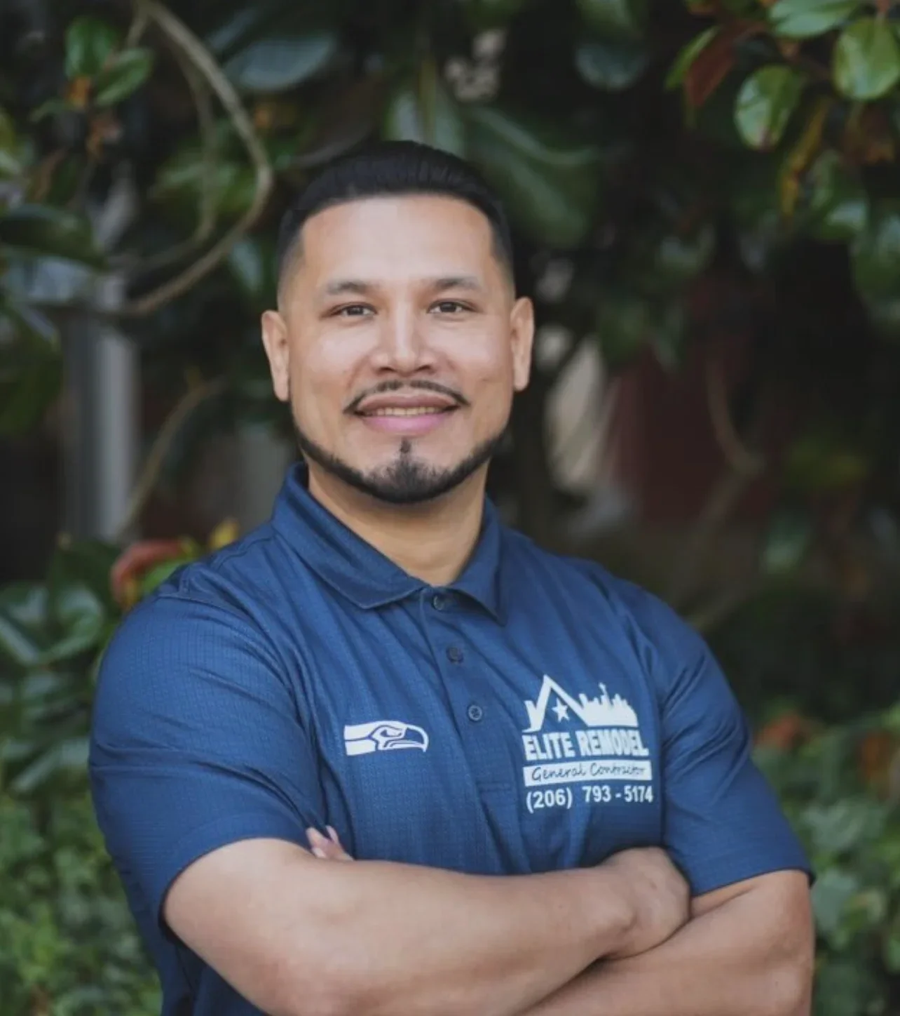Professional headshot of service contractor in blue branded polo shirt